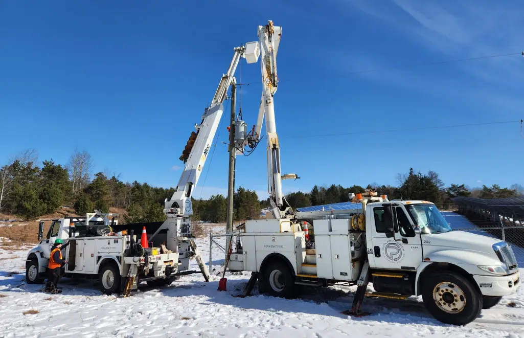Utility pole electrical trucks working